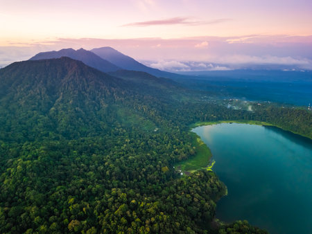 Sunrise Aerial View Of Bali s Tamblingan Lake With Lush Forest And Mountainsの写真素材