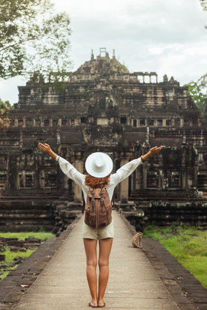 Backpacker Celebrates At Baphuon Temple Causeway, Angkor Thom Cambodiaの写真素材