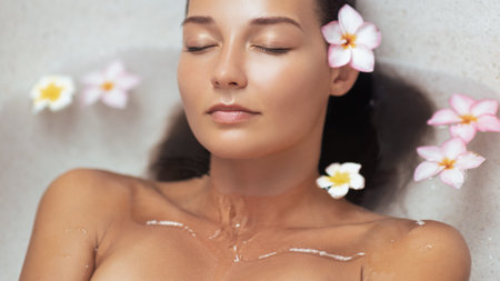 Beautiful Woman Relaxing In Floral Spa Bath With Glowing Skin And Calm