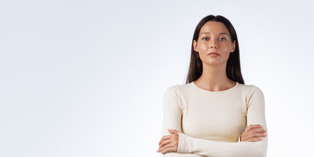 Strong Confident Woman in Sportswear Posing With Arms Crossed Indoorsの写真素材