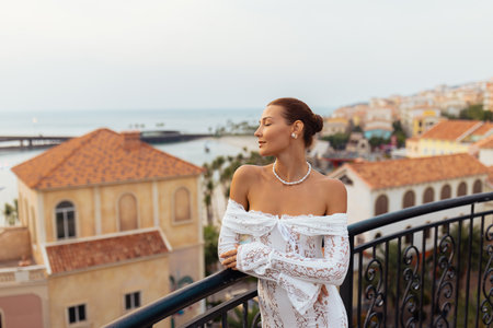 Chic Woman in Lace on Balcony With Ocean and Kiss Bridge View, Phu Quocの写真素材
