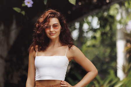 Confident Woman In Boho Chic Outfit Posing In Tropical Gardenの写真素材