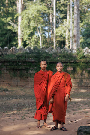 SIEM REAP, CAMBODIA - 10 November 2024: Buddhist Monks At Angkor Temple - Portrait In Orange Robes Outdoorsのeditorial素材