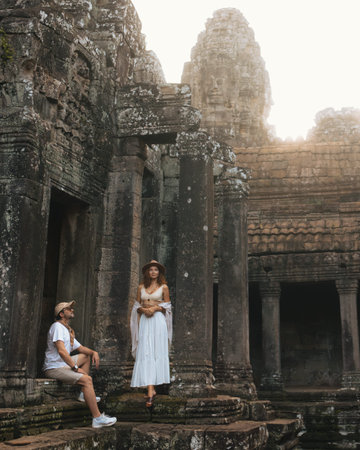 Man and Woman Posing at Bayon Temple Ruins During Travel Adventureの写真素材