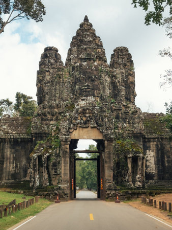 Angkor Thom Gate With Bayon Face Tower On Empty Road, Siem Reap, Cambodiaの写真素材