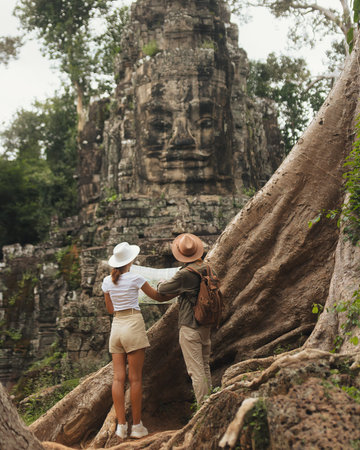 Tourists Reading Map At Bayon Face Tower, Angkor Cambodia Adventureの写真素材