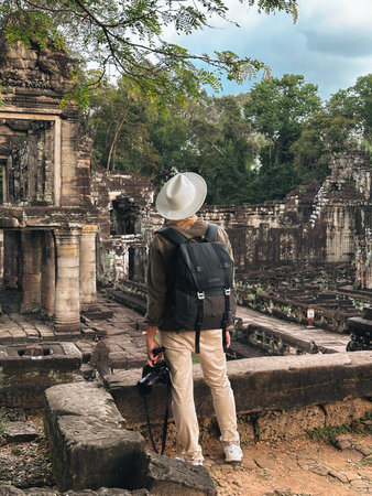 Explorer Standing Before Preah Khan Temple Ruins in Angkor Wat Jungleの写真素材