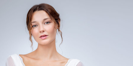 Studio Close-Up Portrait Of Woman In White Lace Dress, Gray Background