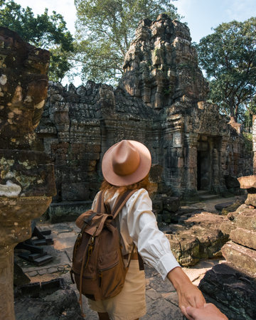 Backpacker Woman Holding Hand and Entering Ta Som Temple, Angkor Watの写真素材