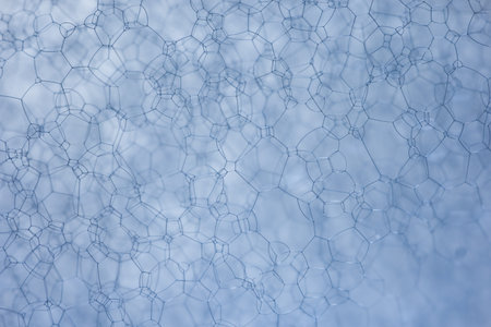 Soap Foam Macro Texture Close Up With Bubble Network On Blue Background