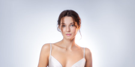 Studio Shot of Sexy Slim Brunette Woman in Elegant White Lingerieの写真素材