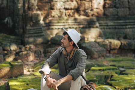 Solo Traveler Sitting Among Ancient Stones of Ta Som Temple Cambodia