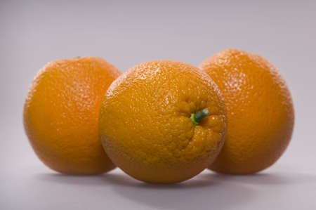 Three oranges on a grey backgroundの写真素材