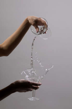 Martini glass in hands of the woman