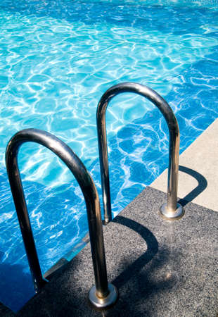 safety rails by a swimming poolの写真素材