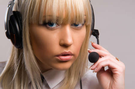 beautiful blonde on the isolated background in headphonesの写真素材