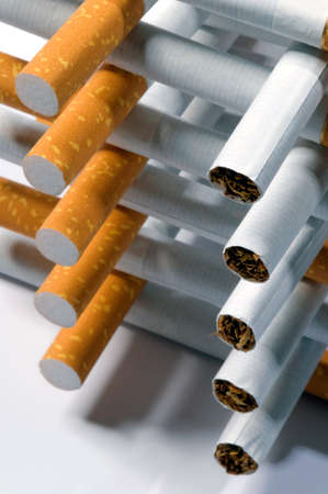 few cigarettes lying on a white backgroundの写真素材