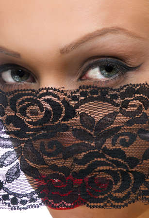 The woman's face with beautiful green eyes covered by a veilの写真素材