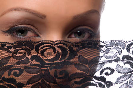 The woman's face with beautiful green eyes covered by a veilの写真素材