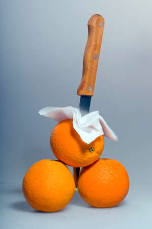 three oranges lying on the ground, covered with drops of waterの写真素材