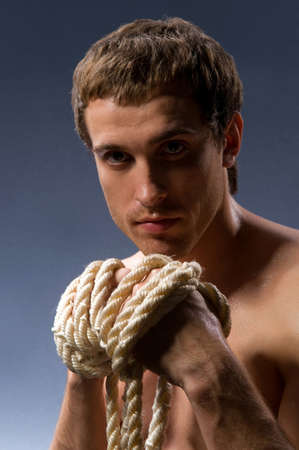 the hands of men squeezed a thick ropeの写真素材