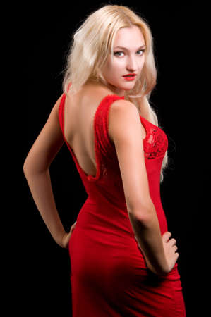 Beautiful blonde woman in evening dress on black backgroundの写真素材