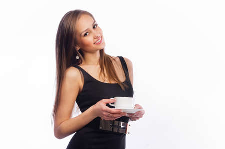 Beautiful young girl drinking coffee or tea on a white backgroundの写真素材