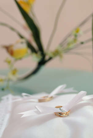 gold wedding rings on a pillow in the registry officeの写真素材