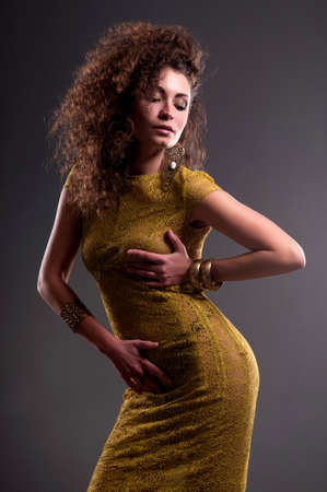 pretty girl in a green dress with a gray backgroundの写真素材