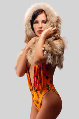 beautiful young woman in a fur hatの写真素材