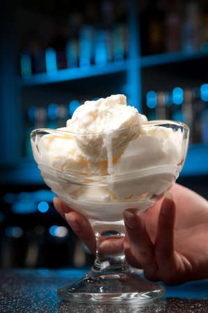 a glass of ice-cream stands on the bar