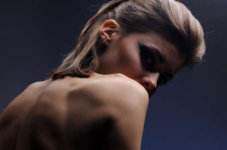 pretty young woman on a blue backgroundの写真素材