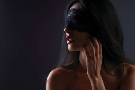 portrait of a girl in a mask with a gray backgroundの写真素材