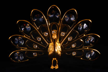 Souvenir peacock with crystal isolated on blackの写真素材