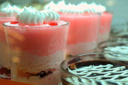 A glass of berry smoothie surrounded by fresh fruitsの写真素材