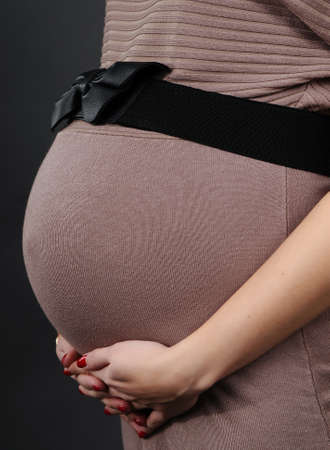 view of a pregnant woman on a gray backgroundの写真素材