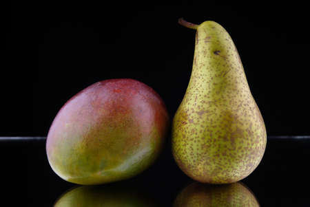 apple on assorted fruits with a black backgroundの写真素材