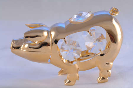 Golden statue of a pig standing with diamondsの写真素材