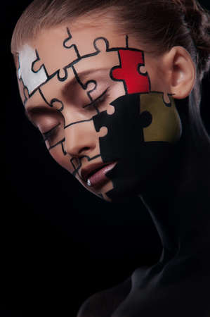puzzles painted on a beautiful woman's faceの写真素材