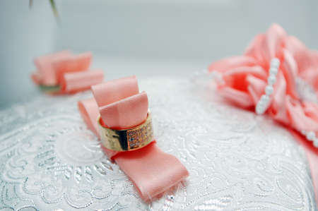 two wedding rings lie on a trayの写真素材