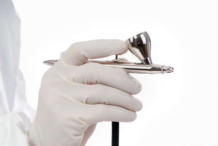 Worker with airbrush gun, isolated on white backgroundの写真素材