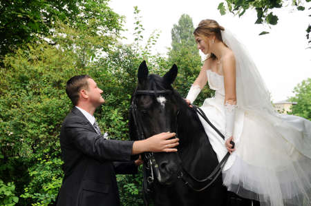 beautiful wedding bride and groom on horsebackの写真素材