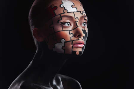 puzzles painted on a beautiful woman's faceの写真素材