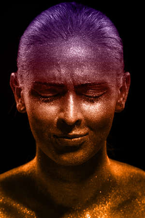 Glitter makeup on a beautiful woman face on a black background. Creative Contemporary Design