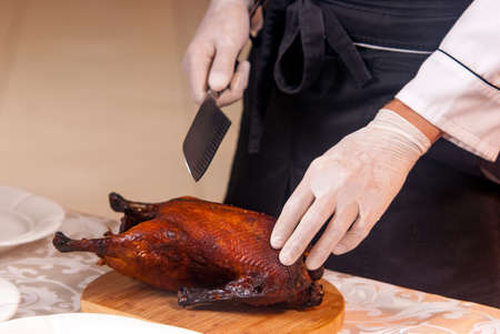 cooking a delicious roast duck with spices in restaurantの写真素材
