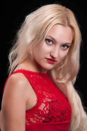 Beautiful woman in evening dress in magenta on a black backgroundの写真素材