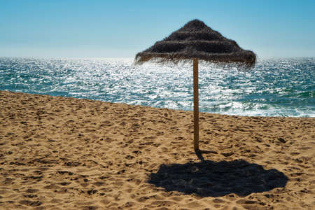 Umbrella at the shore of the Atlantic Ocean, Portugalの写真素材
