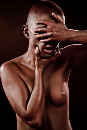 beautiful woman with bodypainting bronze on a black backgroundの写真素材