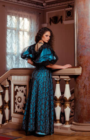 Beautiful women in the clothing of the 18th century in a luxurious interiorの写真素材