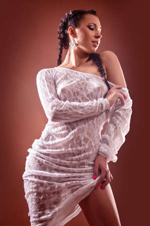 Beautiful, naked and sexy woman on brown backgroundの写真素材